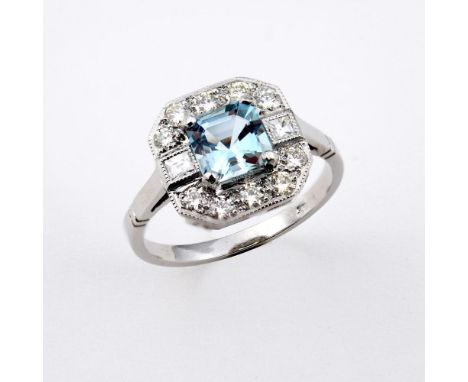 AN AQUAMARINE AND DIAMOND CLUSTER RING. the square-shaped aquamarine is set within a surround of two square-shaped and ten ci