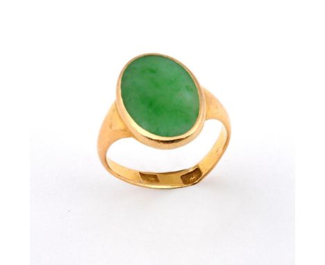 A JADE SINGLE STONE RING. the oval-shaped jade is set within a yellow gold mount. Size J.  **BP 22.5% inc VAT + Lot Fee of £8