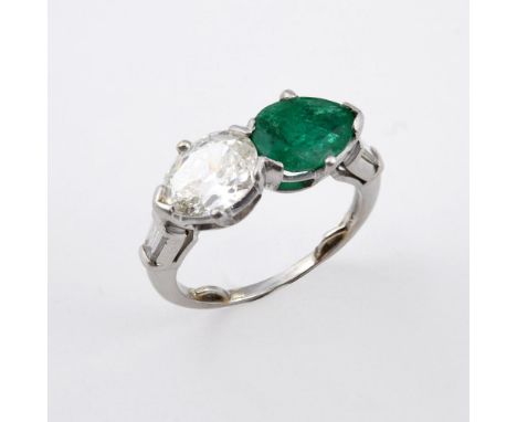 AN EMERALD AND DIAMOND RING. mounted with a pear-shaped diamond and a pear-shaped emerald, with a tapered baguette-cut diamon