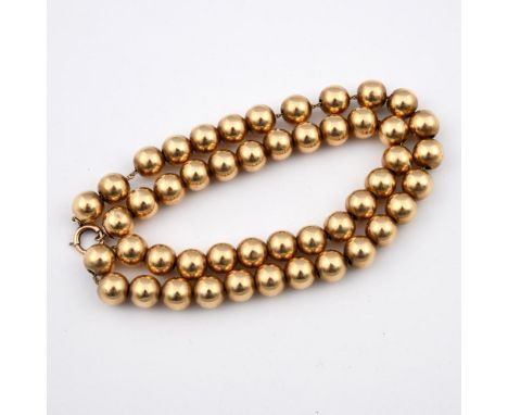 A SINGLE ROW UNIFORM GOLD BEAD NECKLACE. 39cm long, 29 grams.  **BP 22.5% inc VAT + Lot Fee of £8  