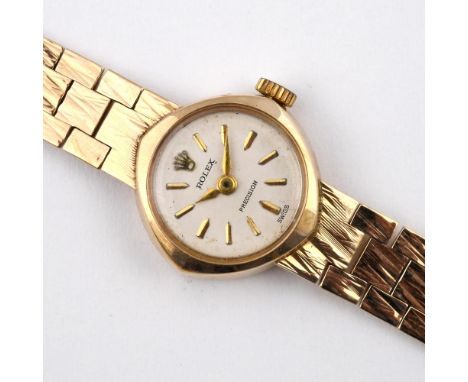 A LADY'S 9CT GOLD WRISTWATCH BY ROLEX. the signed circular dial with baton numerals, on an integrated 9ct gold bracelet with 