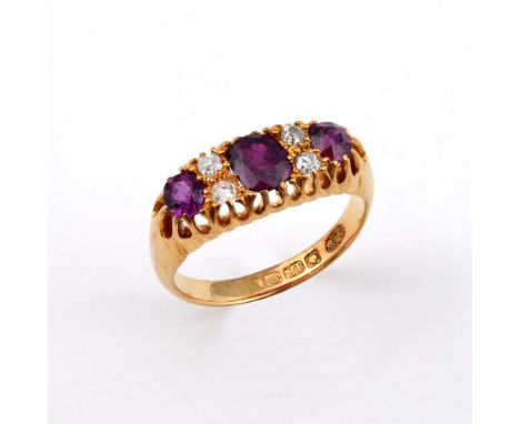 A GARNET AND DIAMOND RING. the three oval-shaped garnets are set with four circular-cut diamonds in 18ct yellow gold. Size L 