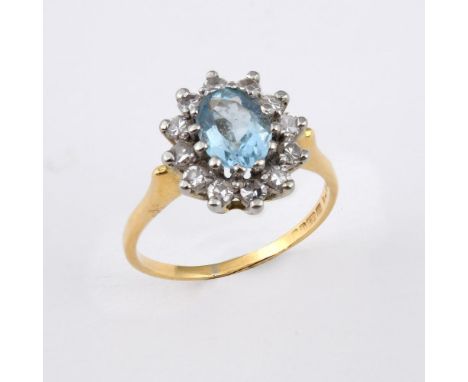 AN AQUAMARINE AND DIAMOND CLUSTER RING. the oval-shaped aquamarine is set within a surround of single-cut diamonds, in 18ct g