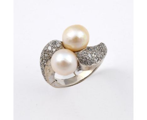 A DIAMOND &amp; CULTURED PEARL CROSS-OVER RING. mounted with two cultured pearls, with millegrain set circular-cut diamonds s