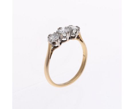 A DIAMOND THREE STONE RING. the three graduated circular-cut diamonds are set in 18ct gold and platinum. Size P.  **BP 22.5% 