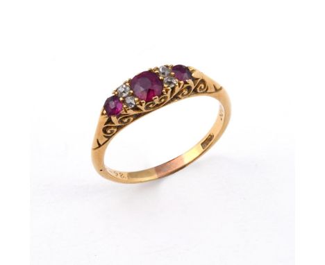 A RUBY &amp; DIAMOND RING. the three oval-shaped rubies are set with four circular-cut diamonds, in yellow gold. Size P.  **B