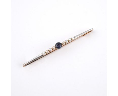 A 15CT GOLD SAPPHIRE AND PEARL BROOCH. the collet set circular-cut sapphire is set with eight small pearls, 5.5cm long.  **BP