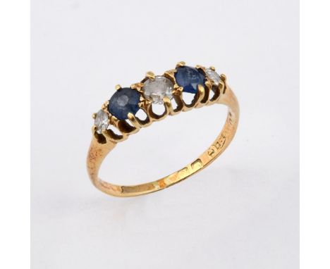 A SAPPHIRE AND DIAMOND FIVE STONE RING. the two circular-cut sapphires are set with three old-cut diamonds, in 18ct yellow go