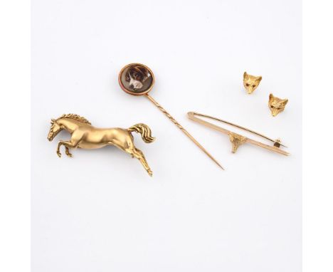 A 9CT GOLD HORSE BROOCH. designed as a leaping horse, 5cm long, 12.9 grams, together with a 9ct gold fox mask brooch and a pa