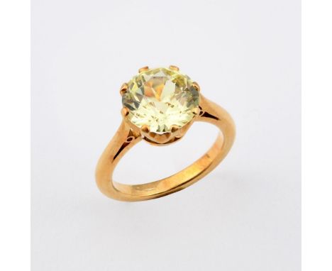 A YELLOW SAPPHIRE SINGLE STONE. the circular-cut yellow sapphire weighs approximately 5.10 carats and is set in yellow gold. 