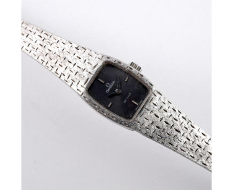 A LADY'S 18CT WHITE GOLD WRISTWATCH BY OMEGA. the signed grey cushion-shaped dial with baton quarters, on an integrated textu