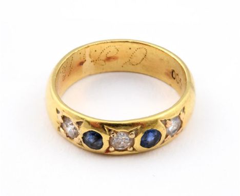 A SAPPHIRE AND DIAMOND HALF HOOP RING. mounted with three circular-cut diamonds and two circular-cut sapphires, in yellow gol