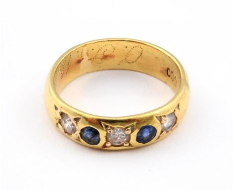 A SAPPHIRE AND DIAMOND HALF HOOP RING. mounted with three circular-cut diamonds and two circular-cut sapphires, in yellow gol