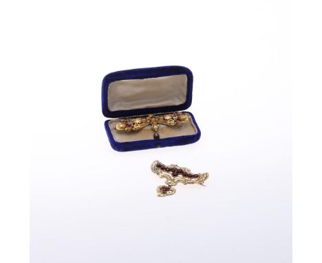 A VICTORIAN GARNET AND GOLD BROOCH. the gold ornate mount set with oval-shaped garnets, 6cm long, together with another garne