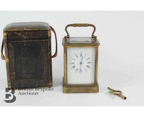 Large brass carriage clock. The clock have a white enamel face with Roman and Arabic dial, bevelled glass panels, approx 8 x 