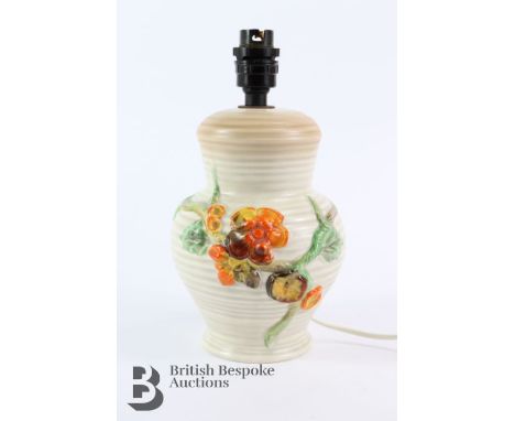 Clarice Cliff Newport Pottery lamp base, ribbed form with a moulded floral design, approx 26 cms h.&nbsp;
