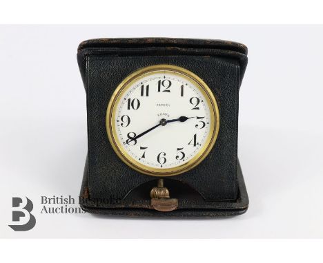Early 20th century Asprey travel clock, white enamel face with Arabic dial, 8-day movement, housed in a black leather folding