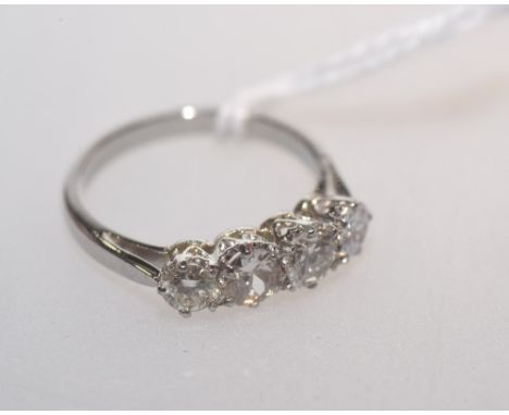 A four stone diamond ring mounted in unmarked white metal (probably Platinum), the four brilliant cut diamonds weighing appro