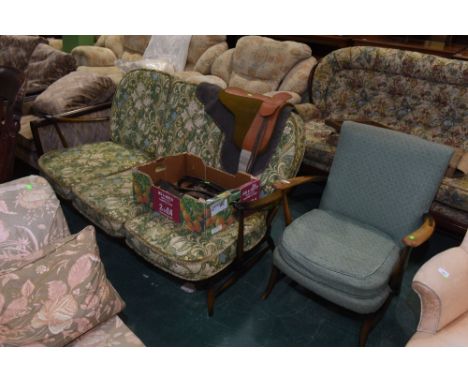 An Ercol three seater sofa with loose cushions in a William Morris pattern; tog. with a vintage open armchair