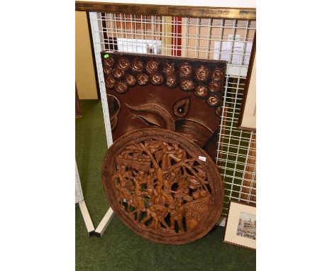 A circular wooden African wall plaque carved with figures beside a tree together with a print of Buddha, unframed. 