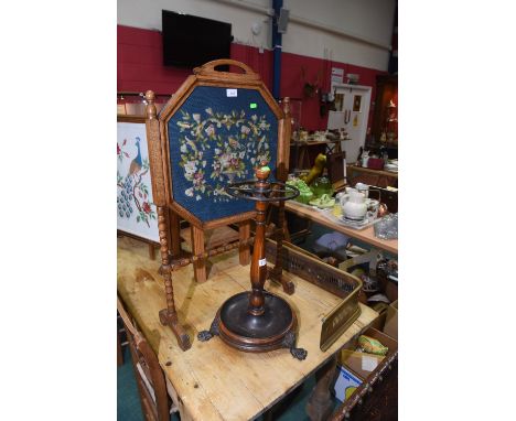 A group comprising an oak framed needlework firescreen, a 19th century mahogany stick stand and a brass fender