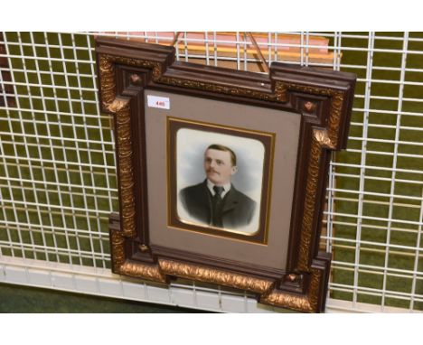 An Edwardian portrait of a young gentleman, watercolour on porcelain, in a parcel gilt frame