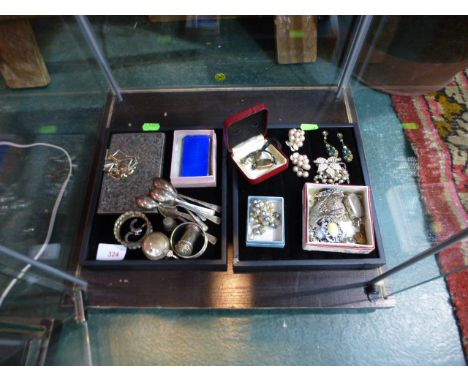 Two small trays inc. a set of six silver egg spoons, Birmingham 1947, a silver bullet shaped pepper pot with blue glass liner