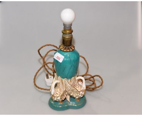 A Worcester Royal Porcelain Works lamp stand, early 20th century  with moulded bullrush decoration above three swans with whi