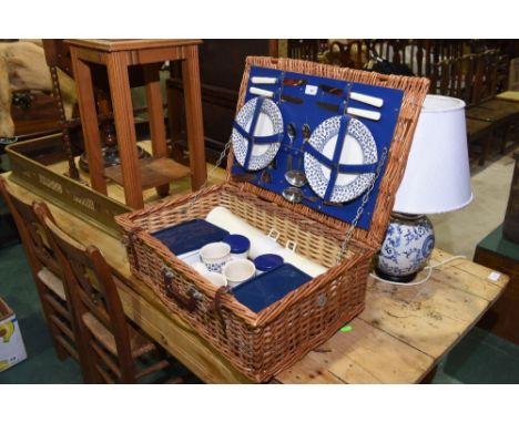 A vintage wicker picnic hamper complete with contents