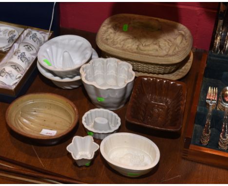 A collection of six white ceramic jelly moulds including a Shelley mould and a Copeland china mould, two brown glazed stonewa