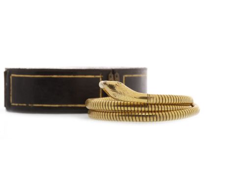 LATE VICTORIAN SERPENT MOTIF BANGLE of expanding form, the serpent's head with decorative engraving, the mouth grasping a sin