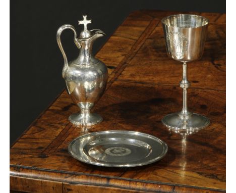 A Victorian silver three piece travelling Communion set, comprising chalice, paten and flagon, each engraved with IHS Christo