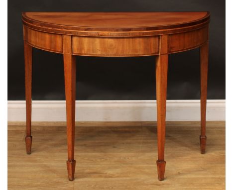 A George III mahogany demilune card table, hinged crossbanded top enclosing a baize lined playing surface, tapered square leg