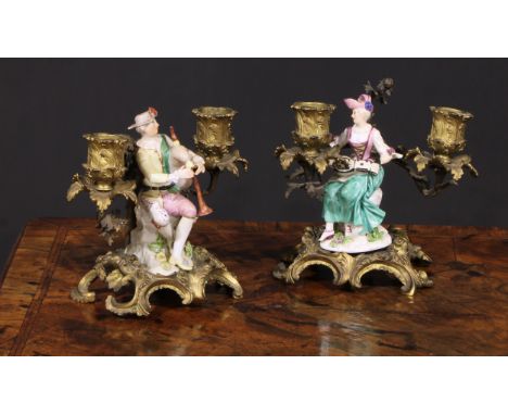 A pair of German porcelain figures, of musicians, mounted upon a pair of ormolu two-light candelabra cast in the Rococo taste