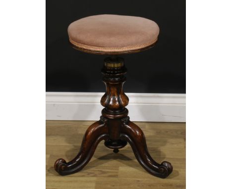 A Victorian walnut adjustable piano stool, stuffed over seat, rising on a lobed baluster column, three scroll legs, centered 