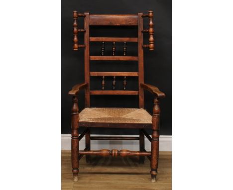 A 19th century Lancashire ash and elm ladder-and-spindle back wool-winding wing chair, rush seat, 105.5cm high, 61cm wide, th