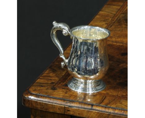 A George V silver bell shaped Christening  mug, of George III design, acanthus capped double scroll handle, skirted base, 9cm