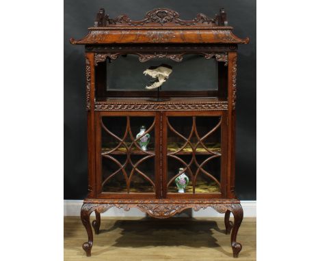 A Chinese Chippendale style mahogany pagoda-form display cabinet, rectangular top above a mirror-back niche and a pair of ast