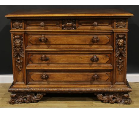 An Italian Renaissance Revival commode, rectangular top with moulded edge above four long drawers, secured with a Wellington-