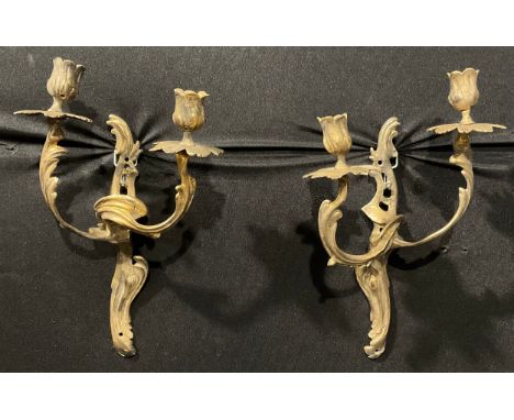 A pair of Rococo Revival gilt metal two-light wall sconces, cast with scrolling acanthus, 32cm high 