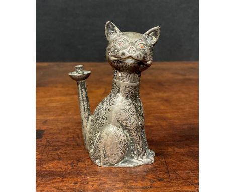 An Edward VII novelty table lighter as a grinning cat, 'Ruby' eyes, seated, the flame from his erect tail, Rd558157, 6cm high