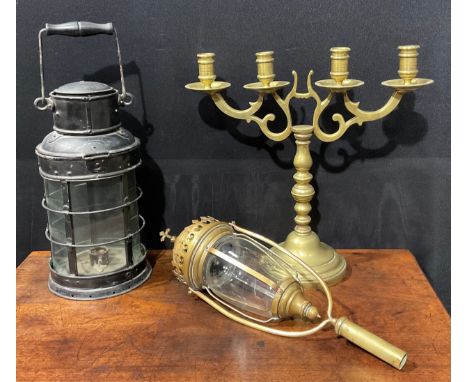 A Gothic Revival brass ecclesiastical processional lantern, foliate cross finial, 47cm long; a painted metal hand lantern; a 
