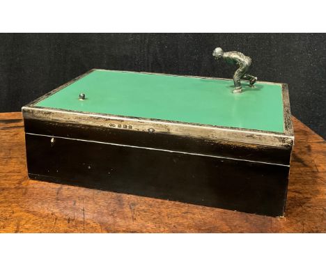 Bowling - a George V silver mounted ebonised cigarette box, hinged cover with a gentleman playing bowls, 17cm wide, Birmingha