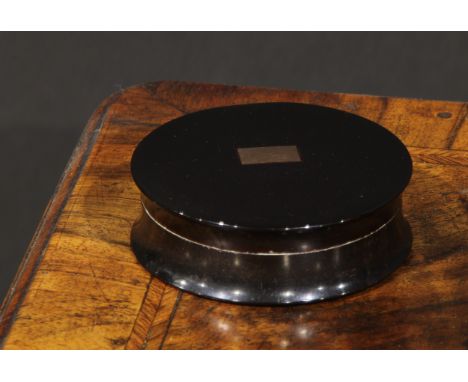 An early 19th century gold coloured metal mounted waisted circular snuff box, push-fitting cover inlaid with a vacant rectang