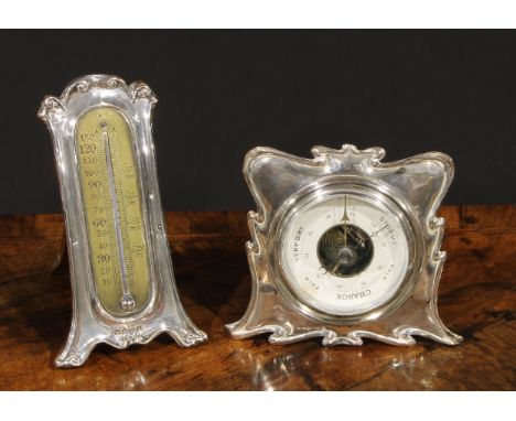 An Edwardian silver easel desk thermometer, scroll border, 15.5cm high, London 1906; an Art Nouveau silver aneroid desk barom