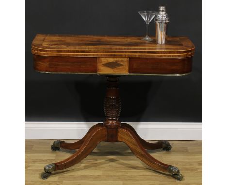 A Regency mahogany banded rosewood card table, hinged top enclosing a baize lined playing surface, turned column, cabriole le