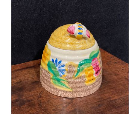 A Clarice Cliff Bizarre Fantasque Petunia pattern ribbed domed honey pot and cover, painted with bright flowers, the cover wi