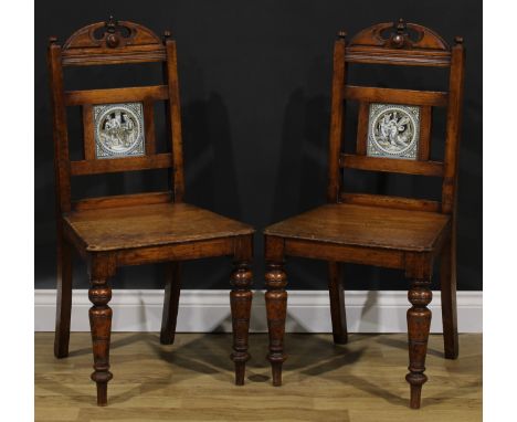 A pair of late Victorian tile back oak hall chairs, of Shakespearean interest, the Shakespeare series tricolour tiles probabl