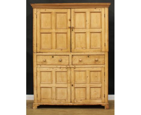 A 19th century pine servants' quarters livery or housekeeper’s cupboard, moulded cornice above a pair of panel doors enclosin