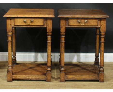 A pair of oak side or lamp tables, possibly by Titchmarsh &amp; Goodwin, each with moulded top above a frieze drawer, 76cm hi